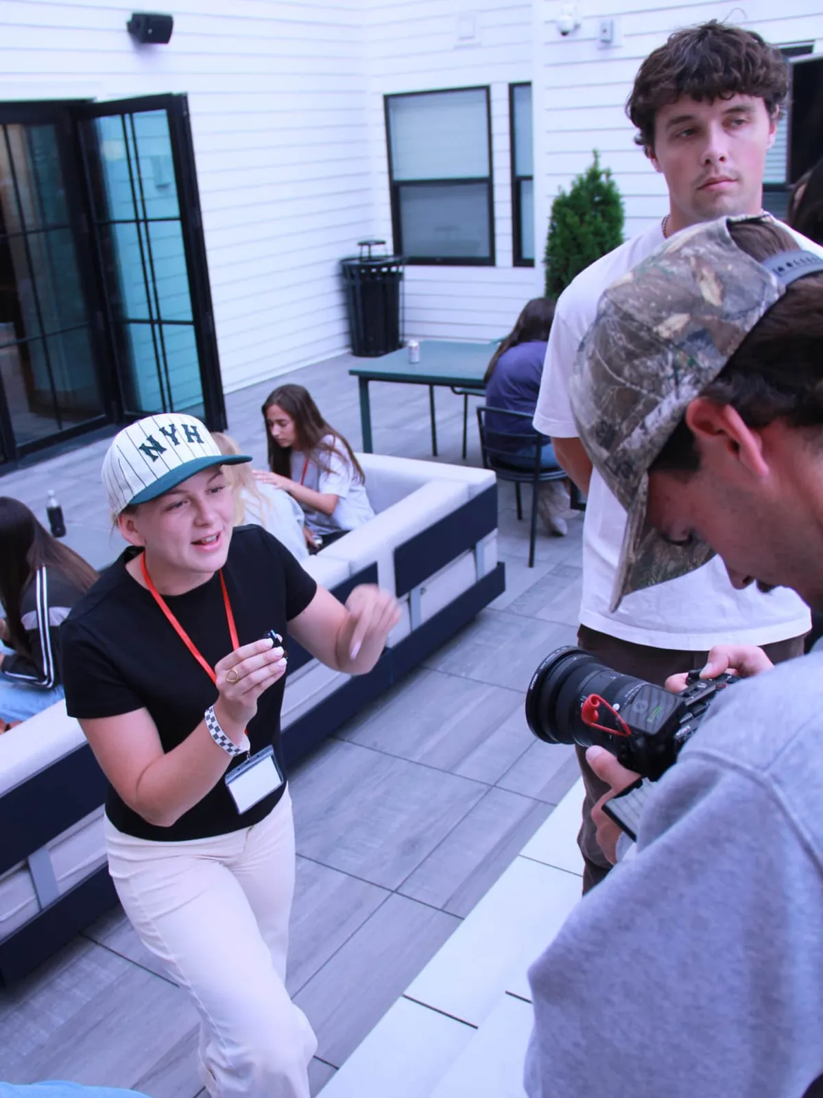 Behind the scenes on a social media content shoot: a host talks to camera while the camera operator films